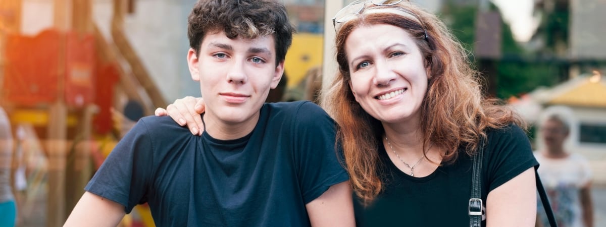 A mother sits with her teen son