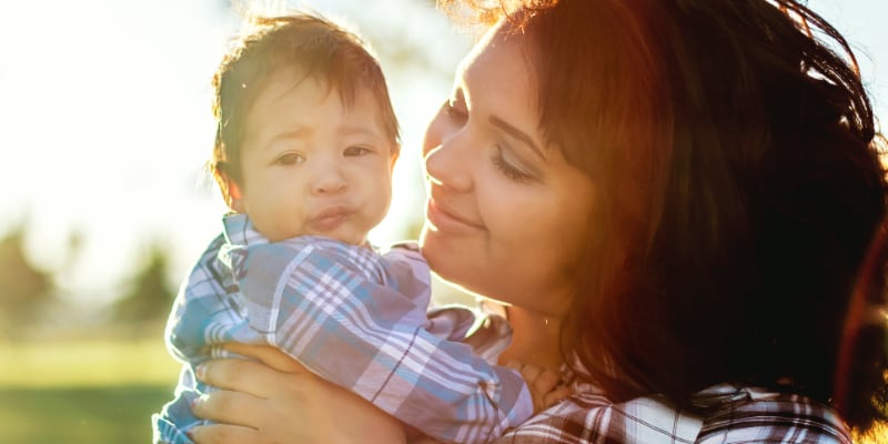 A young mother holding her infant