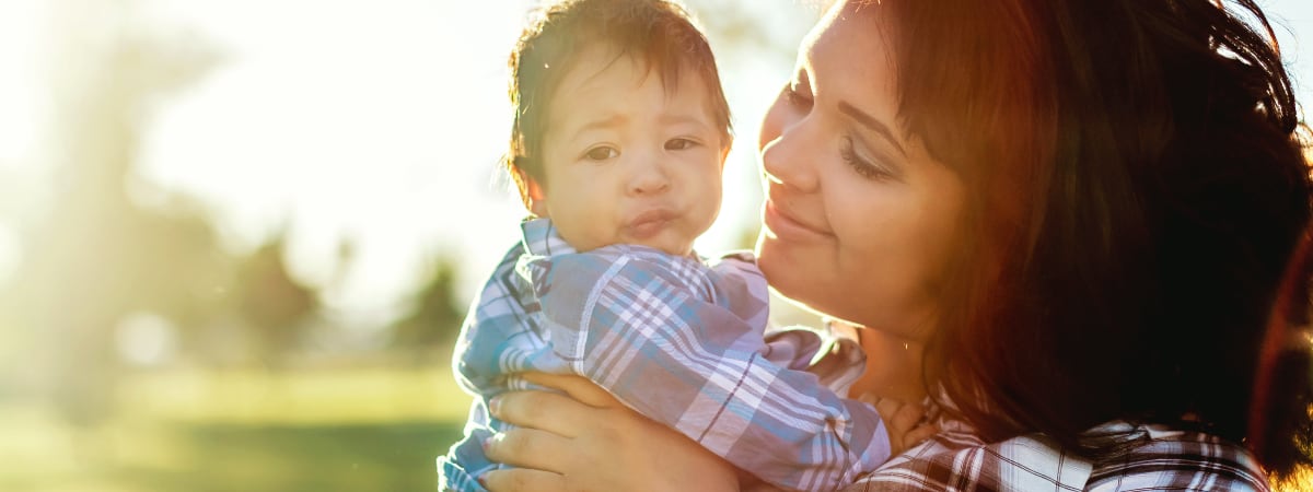 A young mother holding her infant