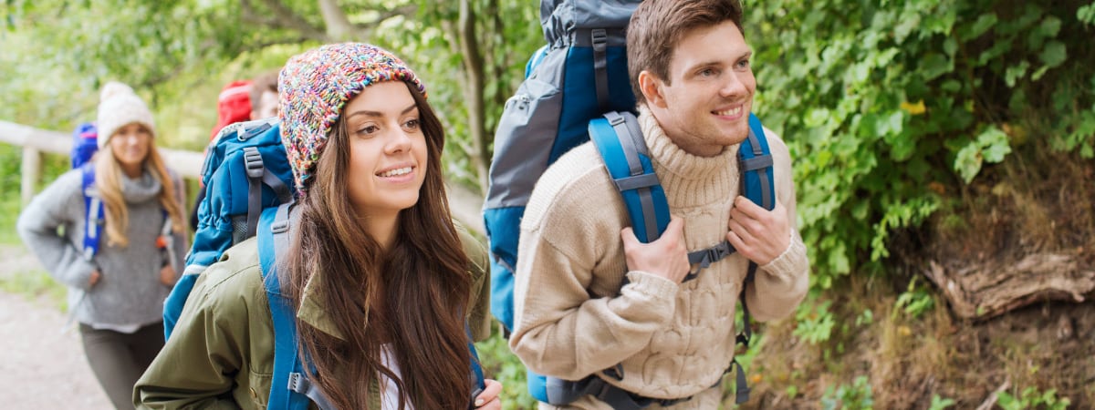 A group of adolescents hiking in the woods